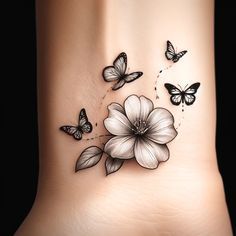 a woman's foot with butterflies and flowers on it