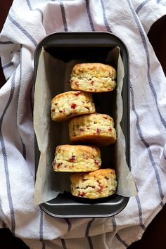 some muffins are in a black tray on a towel