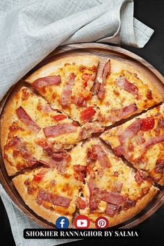 a pizza with ham and cheese cut into slices on a wooden platter, hd png