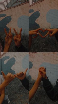 two people holding up their hands in front of a wall with blue and white designs