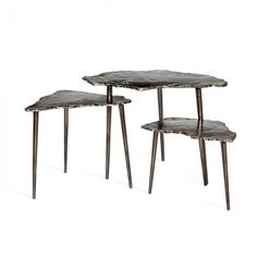 three tables with metal legs on each side and one has a black marble table top