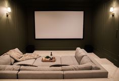 a large couch sitting in front of a projector screen