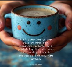 a person holding a blue cup with a smiley face on it and the words, find your happy cup fill it with fun, excitement, hope and motivivity for the rest of the day life is beautiful and you are