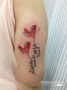 a woman's arm with two hearts and the words happy new year written on it