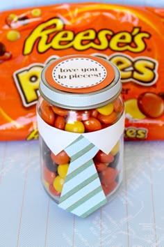 a jar filled with candy sitting on top of a table