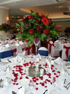 the centerpieces are decorated with red and white flowers