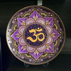 a purple and gold plate with an omelet in the middle on a shelf