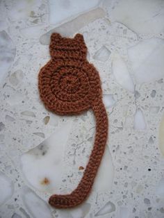 there is a crocheted cat on the ground