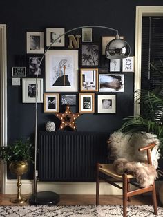 a living room filled with furniture and pictures hanging on the wall next to a radiator