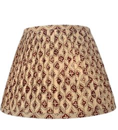 a lampshade with a red and white pattern on the bottom is shown in front of a white background