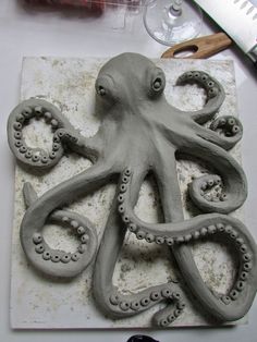 an octopus sculpture sitting on top of a cutting board