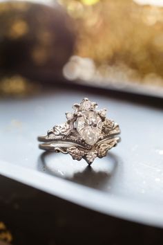 a diamond ring sitting on top of a table