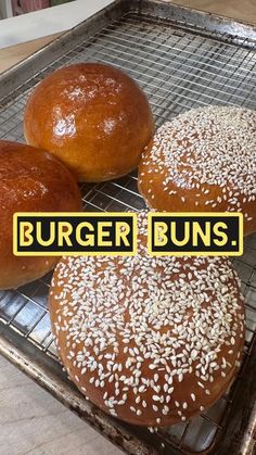 three buns sitting on top of a cooling rack next to each other with the words burger buns