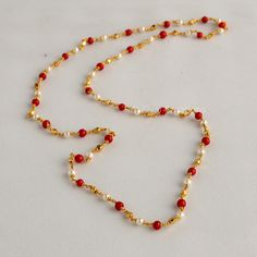 Embrace the allure of tradition with our Coral Pearl Necklace--a fusion of antique charm and Jaipuri elegance. This Mala set, a blend of traditional and fancy elements, features vibrant coral color beads and lustrous pearls. The necklace exudes sophistication, complementing any outfit effortlessly.  This personalized jewelry piece is my own design, and I welcome any customization requests. Elevate your style with this exquisite Indian jewelry. Length - 30 inch Indian Coral Jewellery Gold, Pearl Coral Necklace Indian, Coral And Pearl Jewellery, Red Pearl Necklace For Festive Gift, Red Pearl Necklace Gift For Festive Occasions, Festive Red Pearl Necklace As Gift, Festive Red Pearl Necklace For Gift, Festive Red Pearl Necklace Gift, Elegant Kundan Necklace For Puja And Festive Occasions