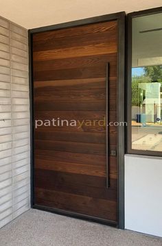 a modern wooden door in front of a house