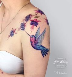 a woman's chest with a hummingbird and flowers on it, painted in watercolor