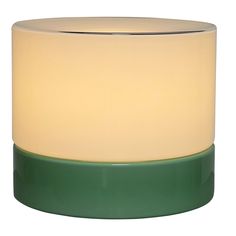 a white and green lamp sitting on top of a table