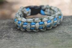 a blue and beige bracelet sitting on top of a wooden table