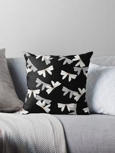 a black and white dragonfly pattern on a pillow sitting on top of a couch