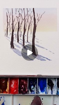 an artist's palette with trees painted in watercolor