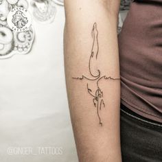 a woman's arm with a tattoo on it that has a line drawing of a swimmer