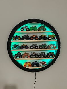 a clock that has some cars on the front and sides with lights around it to illuminate people's interest