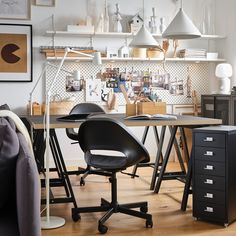 an office with desk, chairs and shelves