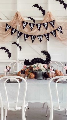 a white table topped with lots of halloween decorations