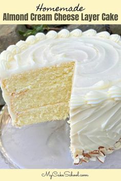 a cake with white frosting is cut into slices and sits on a glass plate