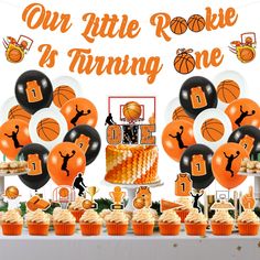 an orange and black basketball themed birthday party with cupcakes, cake, and decorations