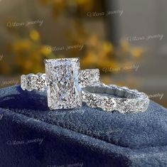 a princess cut diamond engagement ring set on top of a blue velvet cushioned box