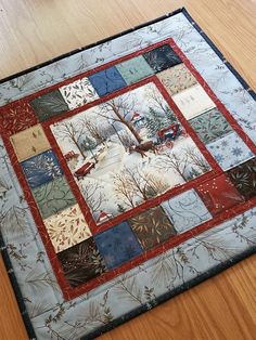 a quilted table topper on a wooden floor with a red car parked in the background