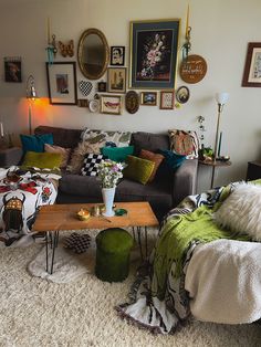 a living room filled with lots of furniture and pictures on the wall above it's coffee table