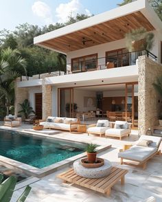 a house with a pool and lounge chairs around it