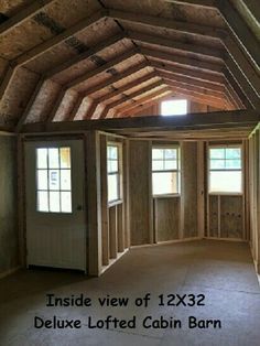 inside view of 12x32 deluxe lofted cabin barn with double doors and windows