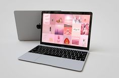 an open laptop computer sitting on top of a white table next to a macbook pro