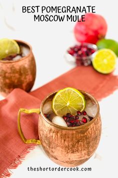 two moscow mules with lime slices and pomegranate garnishes