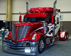 a red semi truck parked in a garage