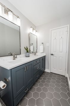 a bathroom with two sinks and a large mirror