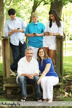 a family sitting on a bench in the park