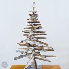 a wooden christmas tree made out of driftwood