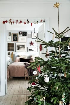 a small christmas tree in the corner of a room