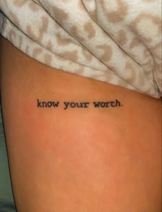 a woman's thigh with the words know your worth written on her lower back