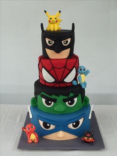 a three tiered cake decorated with various cartoon characters on it's top layer