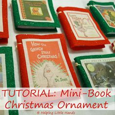 mini - book christmas ornaments are displayed on a table with red and green trimmings