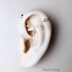 a pair of ear piercings on top of a white object