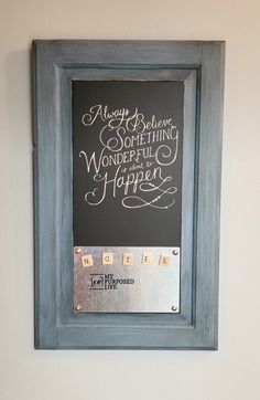 a framed chalkboard with writing on it