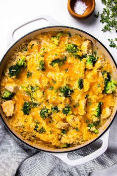 a casserole dish with chicken and broccoli in it on a table