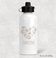 a white water bottle with a heart shaped design on the front and bottom, in gold foil