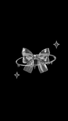 a silver bow and stars on a black background